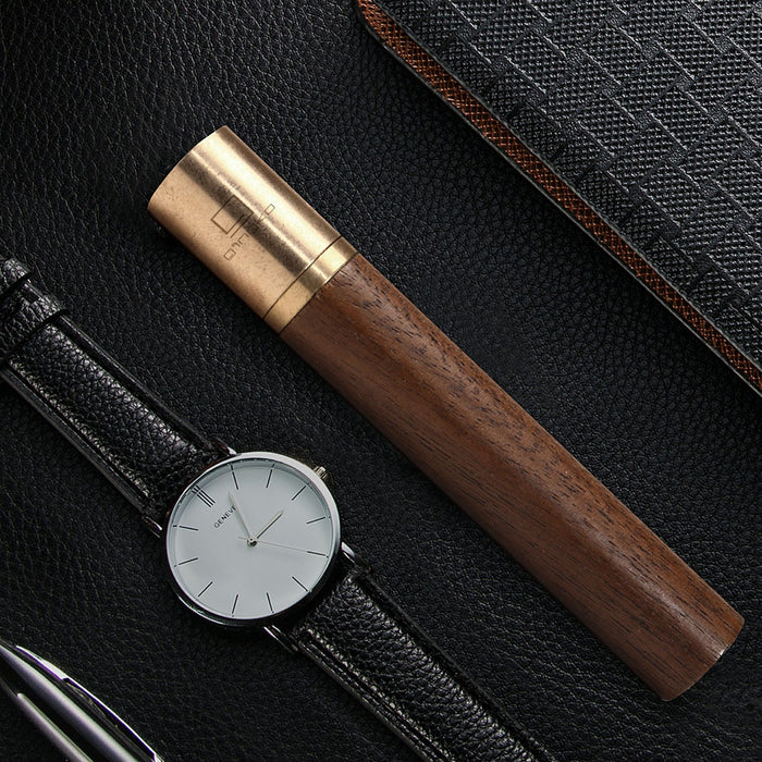 gingko natural wood flameless lighter in american walnut pictured next to a watch with a black leather strap