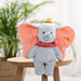An image of Dumbo plush sitting on a wooden stool 