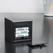 rear view of Gingko cube click clock in black showing the battery compartment open with batteries inside