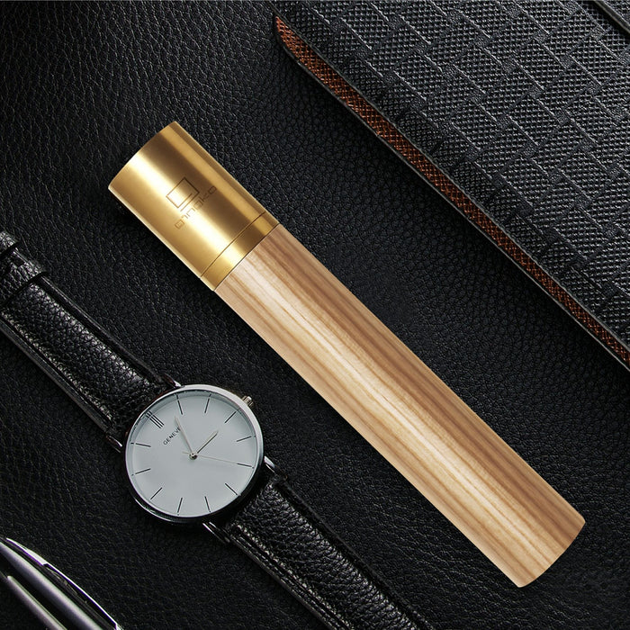 gingko natural wood flameless lighter in white ash placed next to a watch with a black leather strap