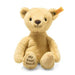 A honey coloured teddy bear with a yellow Steiff tag in the ear and 'my first Steiff' embroidered on the foot