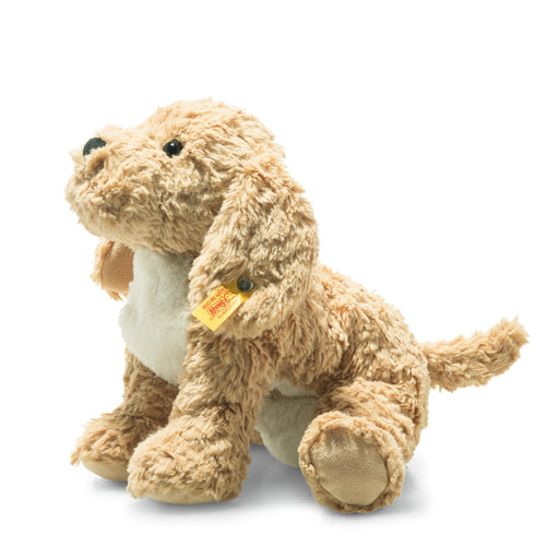 Plush toy dog with a visible brand tag on a white background