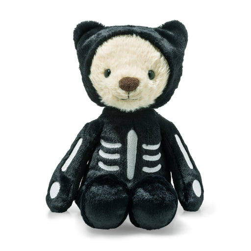 Plush toy bear dressed in a black skeleton costume on a white background