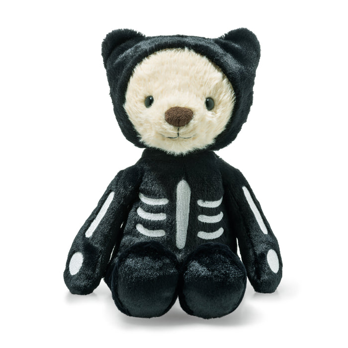 Plush toy bear dressed in a black skeleton costume on a white background