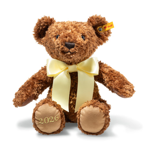 Brown teddy bear with a pale yellow satin bow and '2026' embroidered on the right paw of the bear. 