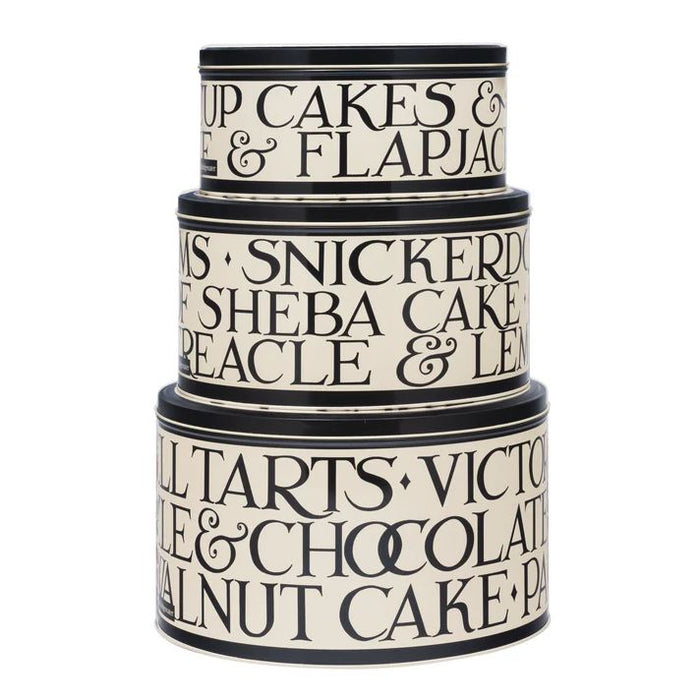 Stack of three decorative cake tins with text on a white background