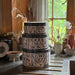 Stack of decorative tins with text on a kitchen counter
