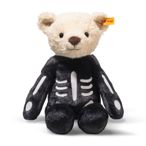 Plush teddy bear in a skeleton costume with a visible Steiff logo tag in ear.