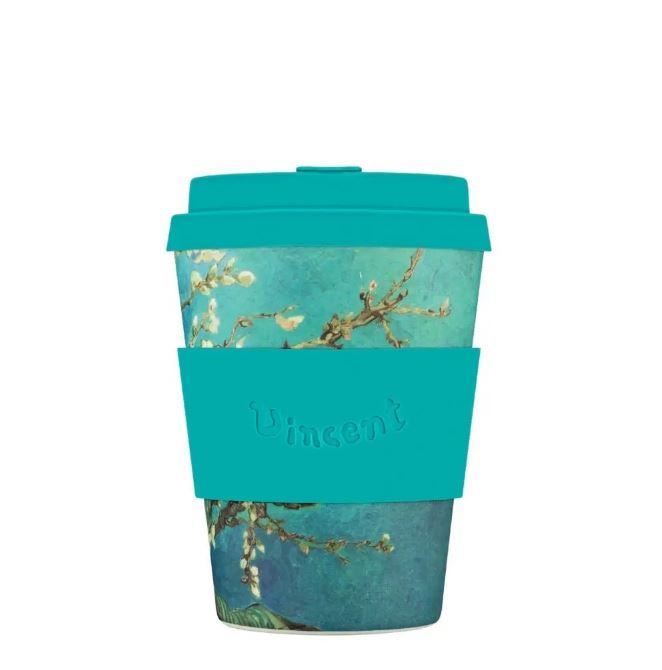 Reusable coffee cup with a floral design and teal lid and sleeve on a white background