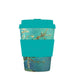 Reusable coffee cup with a floral design and teal lid and sleeve on a white background