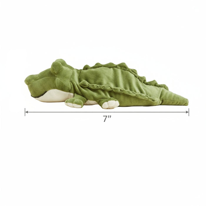 Green plush toy resembling a dragon on a white background