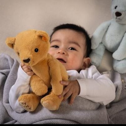 image of a little boy playing with the bear 