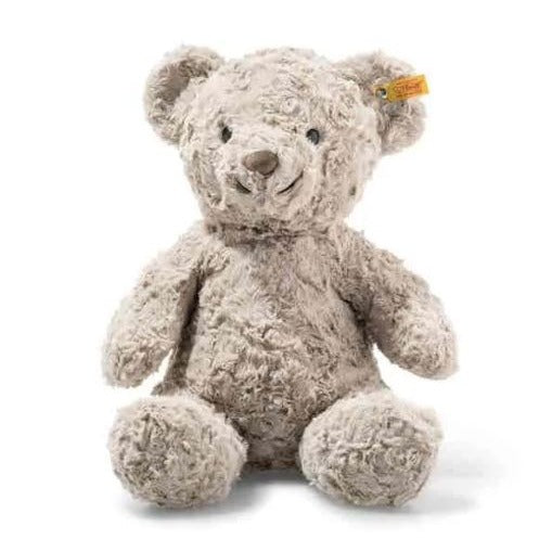 An image of the Steiff cuddly friends Honey plush bear in the colour beige grey