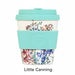Reusable coffee cup with floral design and turquoise lid and sleeve on a white background
