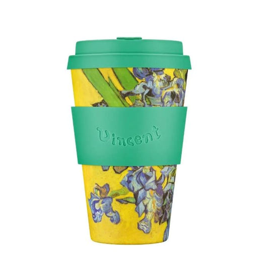 Reusable cup with green lid and sleeve, featuring a colorful design on a white background