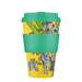 Reusable cup with green lid and sleeve, featuring a colorful design on a white background