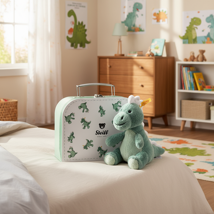 Green Steiff plush toy with suitcase in a child's room with dinosaur decor