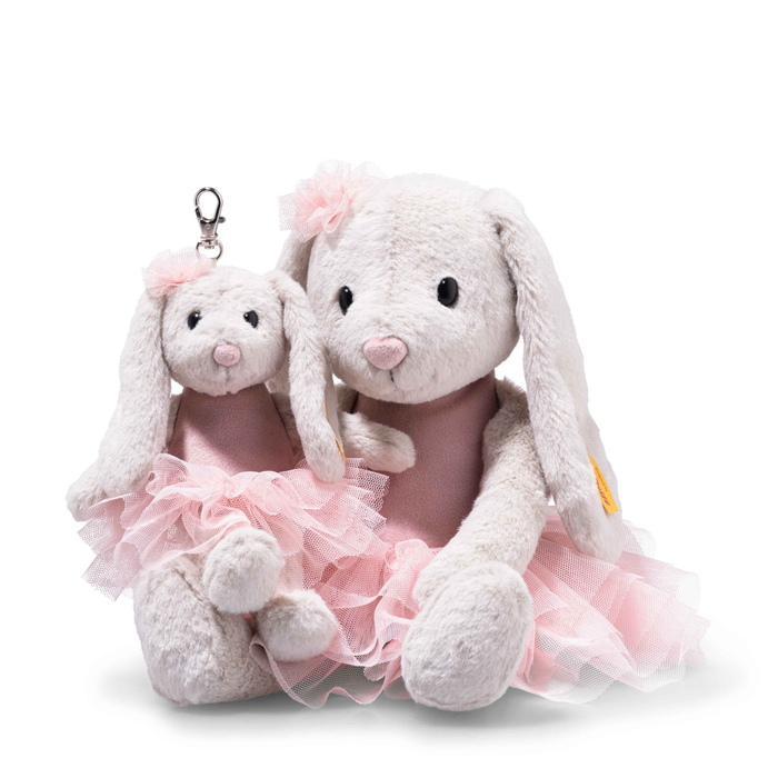 Two plush toys, one with a keychain and the other in a pink tutu, on a white background.
