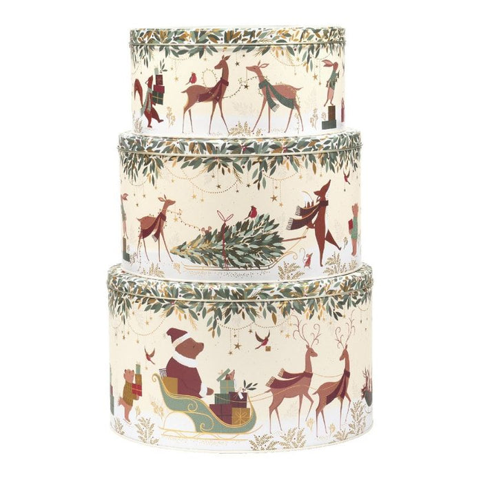 Set of three decorative Christmas-themed cylindrical boxes with reindeer and Santa Claus designs.