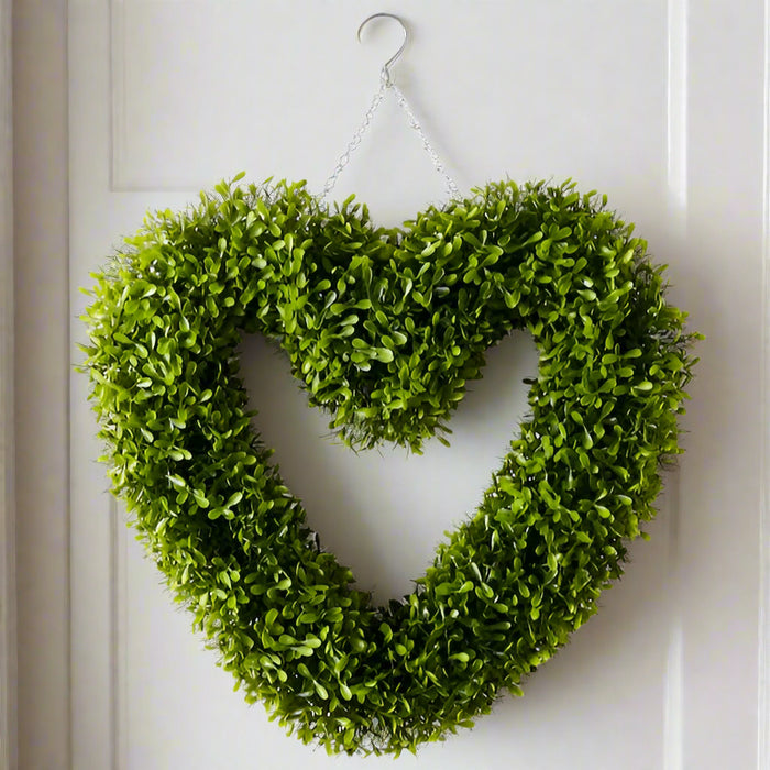 Heart-shaped green wreath on a white background