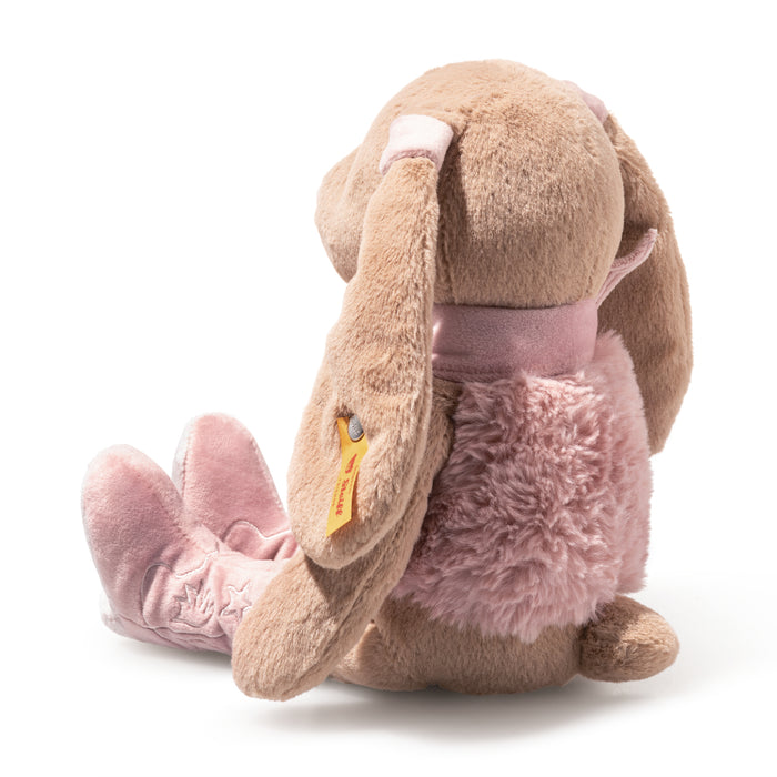 Plush toy rabbit with pink bow and fluffy tail on a white background