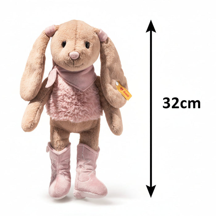 Plush rabbit toy with pink outfit and boots on a white background