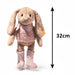Plush rabbit toy with pink outfit and boots on a white background