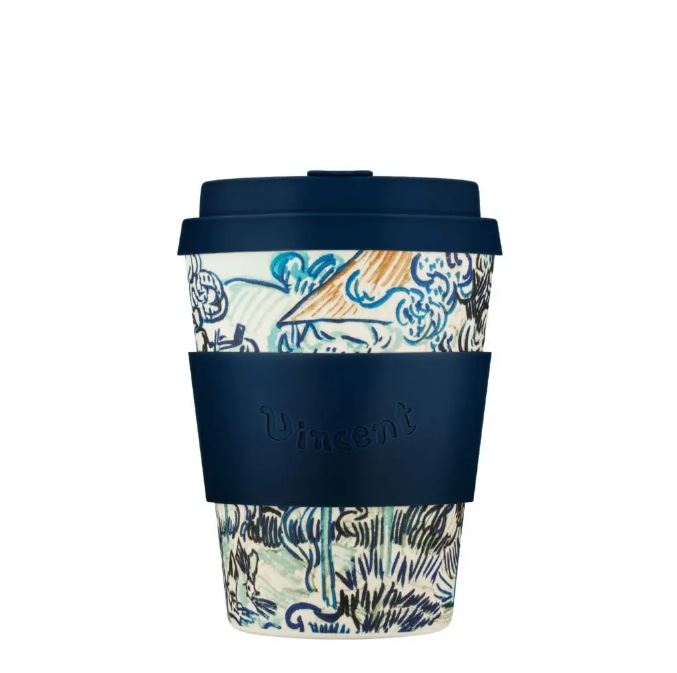 Reusable coffee cup with patterned design and navy lid and sleeve on a white background