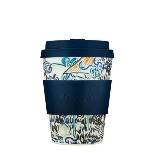 Reusable coffee cup with patterned design and navy lid and sleeve on a white background