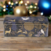 Decorative tin box with gold animal and nature patterns on a dark blue background