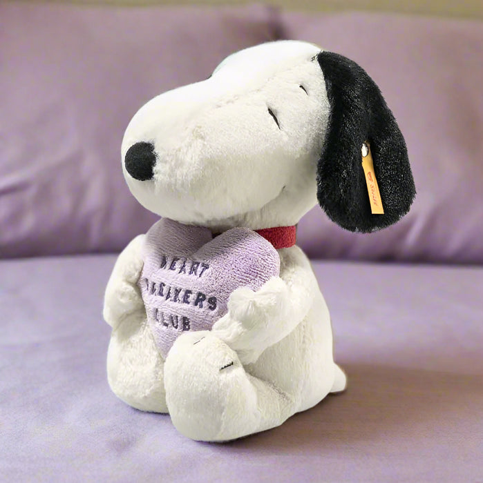 Plush dog toy with a heart-shaped tag on a purple background