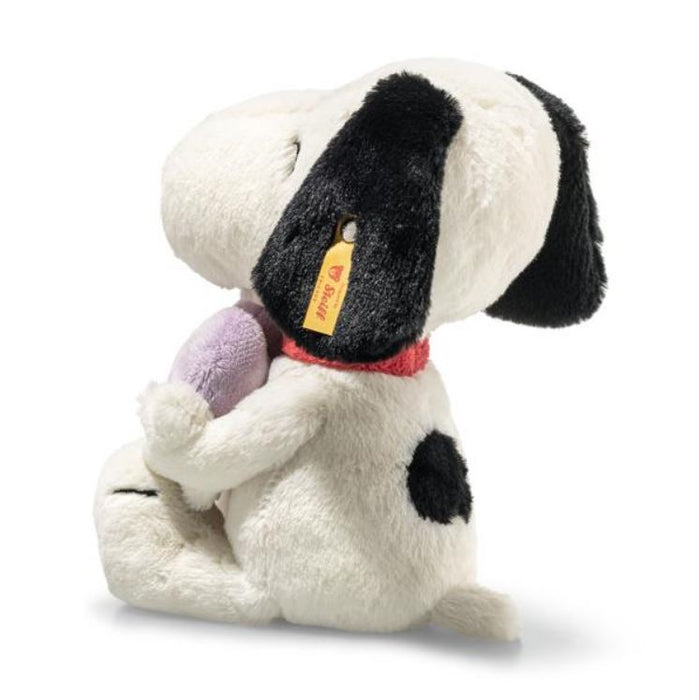 Plush dog toy with a purple heart on a white background