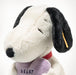 Plush dog toy with black and white face, red collar, and purple heart on a white background