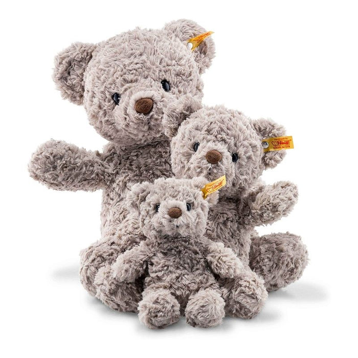 Three plush teddy bears of different sizes on a white background