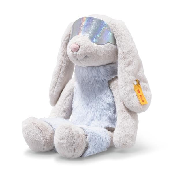 Plush toy rabbit with rainbow-colored eyes on a white background