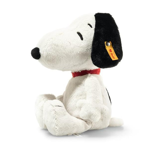 Plush toy resembling a dog with a black nose and red collar on a white background