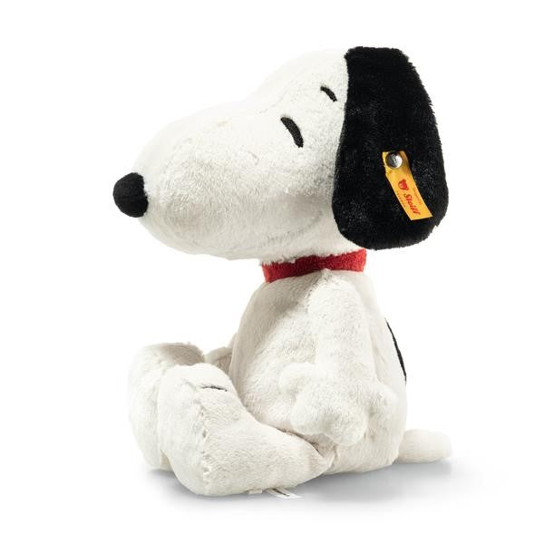 Plush toy resembling a dog with a black nose and red collar on a white background