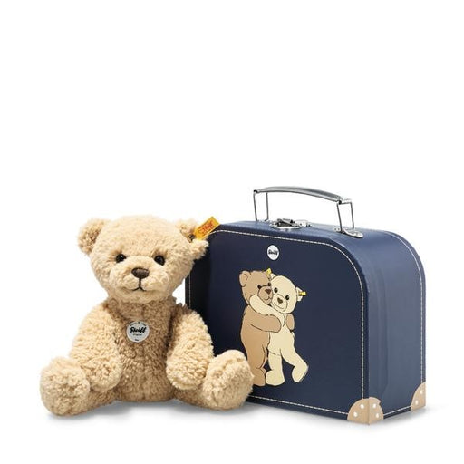 Teddy bear with a navy blue suitcase featuring another teddy bear design on a white background