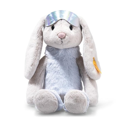 Plush toy rabbit with a silver tiara on a white background