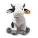 Plush cow toy with black and white pattern on a white background