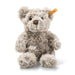 Plush teddy bear with a visible brand tag on a white background