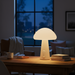 Mushroom-shaped lamp with a beige base and white cap on a white background