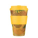 Reusable coffee cup with sunflower design and yellow lid and sleeve on a white background
