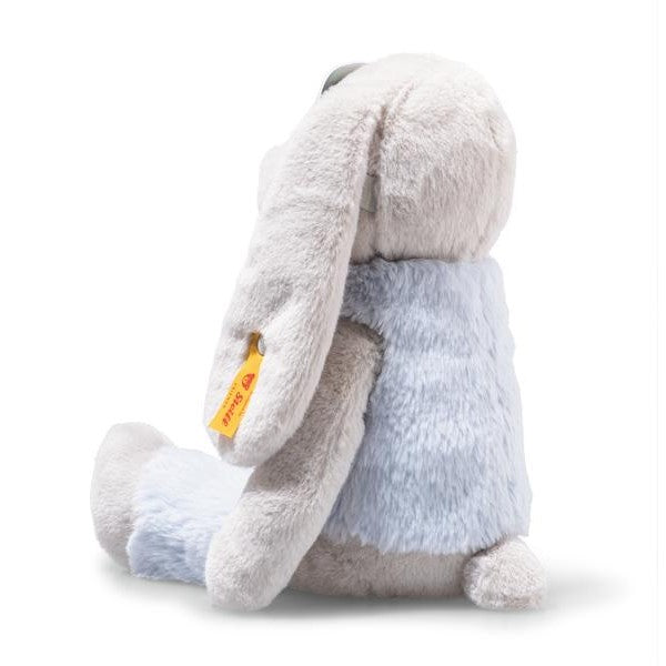 Plush toy rabbit with a visible brand tag on a white background