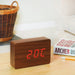 Gingko brick LED click clock in a walnut coloured wooden effect displaying the temperature in red