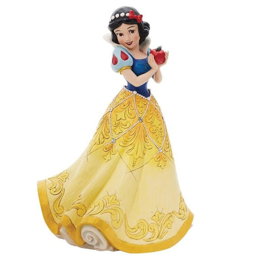 With jewels and Swarovski crystals, Snow White wears a yellow skirt detailed with Swarovski crystals and a blue top. She has a red bow in her black hair and a sweet smile. She holds the famous apple in her delicate grip as the poison inside shines in metallic paint.