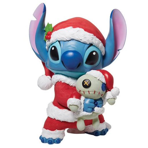 Santa Stitch Statement Figurine is featured here wearing a red Santa hat and Santa jacket. Stitch is hugging Scrump, Lilo's homemade rag doll who is also wearing a matching red Santa hat. 