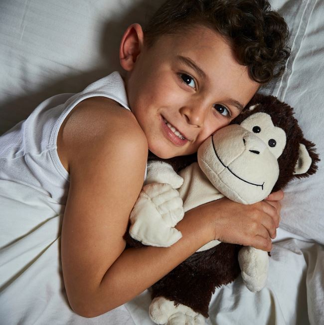 young boy holding 13" heat up monkey toy