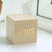Gingko Cube LED Click Clock in a Maple effect, displaying the time in yellow