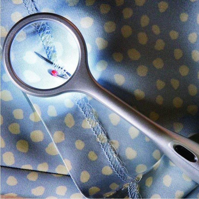 arts and crafts LED lighted seam ripper being used on a garment